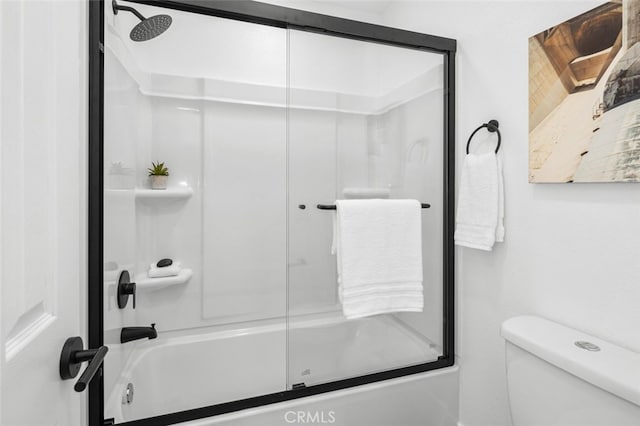 bathroom with toilet and enclosed tub / shower combo