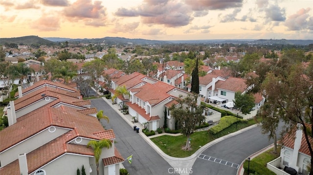 drone / aerial view featuring a residential view and a mountain view