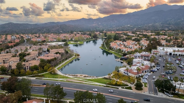 birds eye view of property with a residential view and a water and mountain view