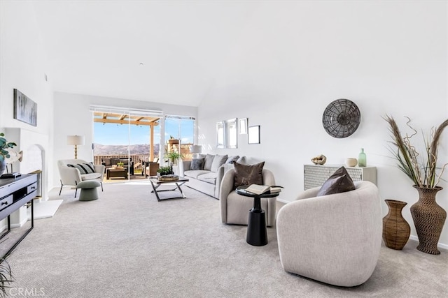 carpeted living room featuring high vaulted ceiling