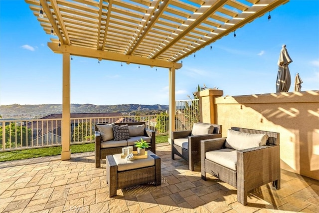 view of patio with a mountain view, fence, outdoor lounge area, and a pergola