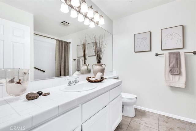 bathroom with visible vents, baseboards, toilet, tile patterned floors, and vanity