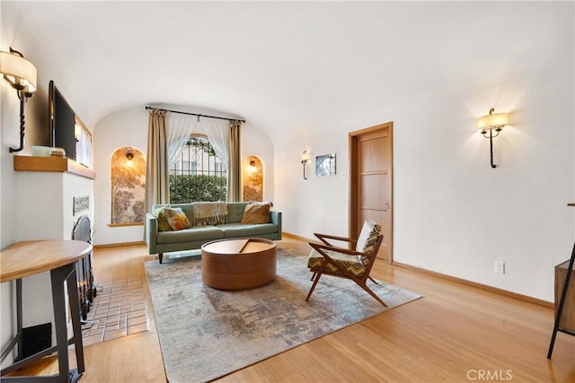 living room featuring baseboards and light wood-style floors