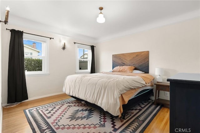 bedroom featuring light wood-type flooring and baseboards