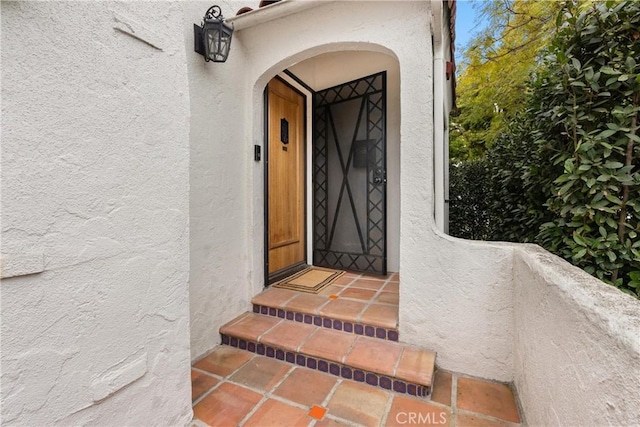 doorway to property with stucco siding