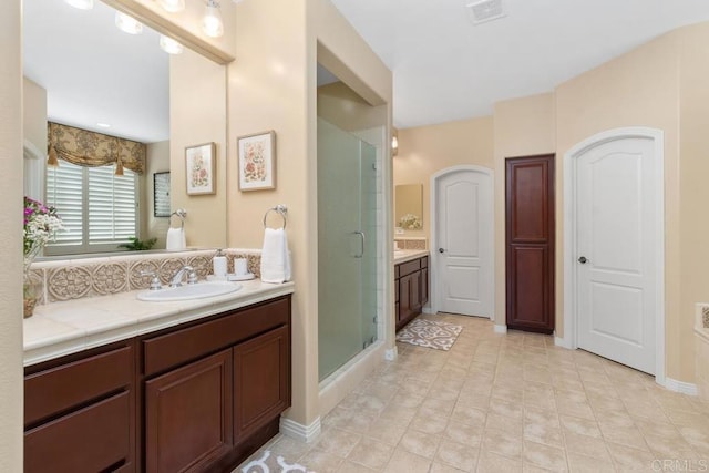 full bath with vanity, visible vents, and a shower stall