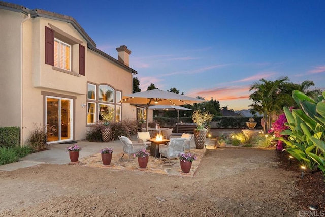 exterior space featuring an outdoor fire pit and a patio area