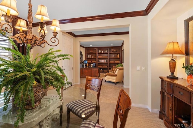 dining room featuring an inviting chandelier, baseboards, and crown molding