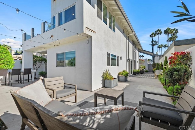 view of patio featuring fence and an outdoor living space