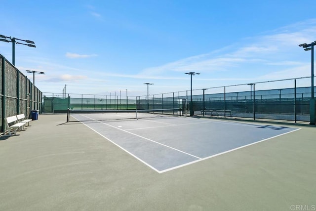 view of sport court featuring fence