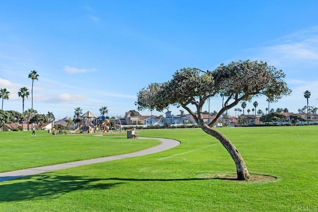 surrounding community featuring playground community and a lawn