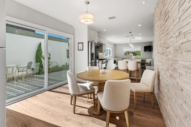 dining room featuring light wood-type flooring, visible vents, and recessed lighting