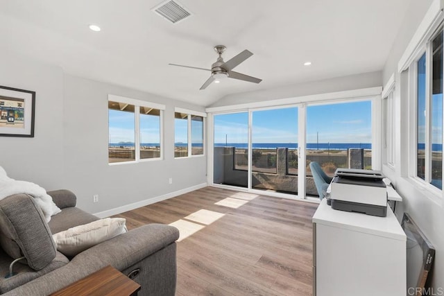 living area with visible vents, baseboards, light wood-style flooring, a water view, and recessed lighting