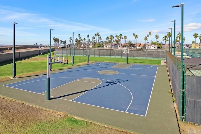 view of basketball court featuring community basketball court, a yard, and fence