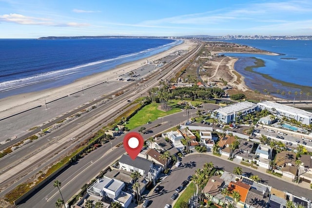 bird's eye view with a water view and a beach view