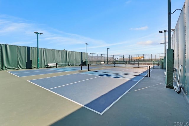 view of sport court featuring fence