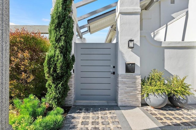 entrance to property featuring stucco siding