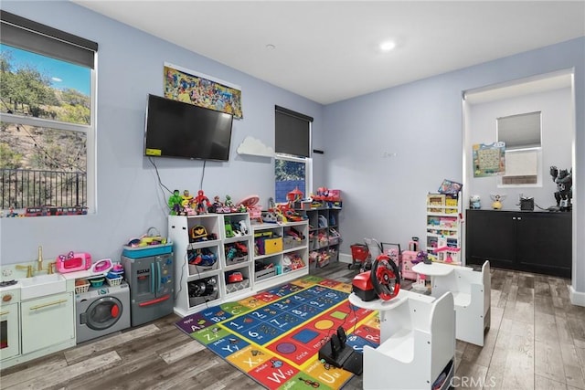 playroom featuring wood finished floors and baseboards