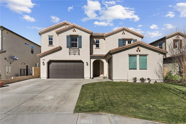 mediterranean / spanish-style house with stucco siding, an attached garage, driveway, a tiled roof, and a front lawn