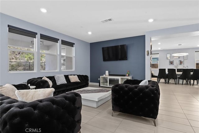 living area with a wealth of natural light, visible vents, recessed lighting, and light tile patterned flooring