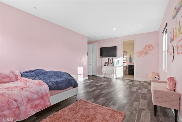 bedroom with baseboards and wood finished floors