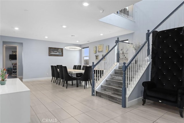 stairway featuring tile patterned floors, baseboards, and recessed lighting