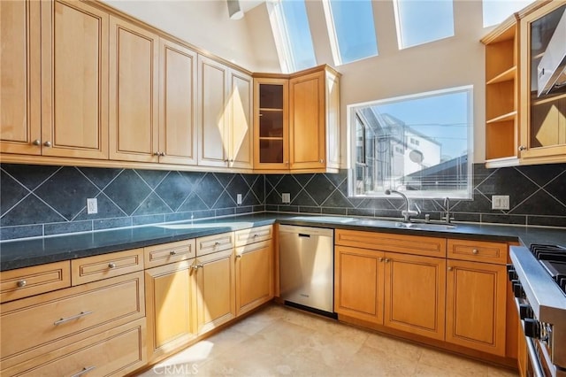 kitchen with stove, a sink, stainless steel dishwasher, tasteful backsplash, and glass insert cabinets