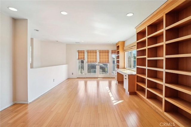 unfurnished room with recessed lighting, light wood-style floors, and baseboards