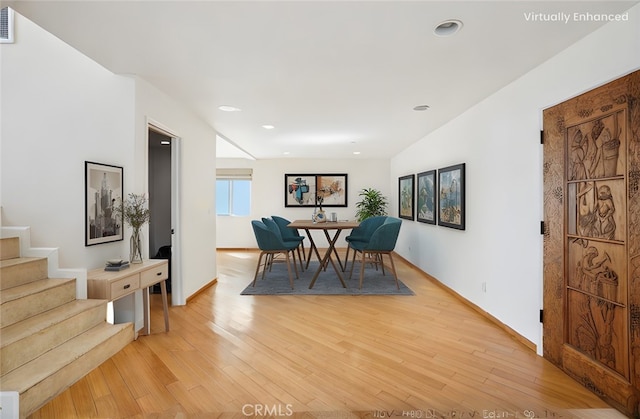 dining space with visible vents, baseboards, light wood-style flooring, stairs, and recessed lighting