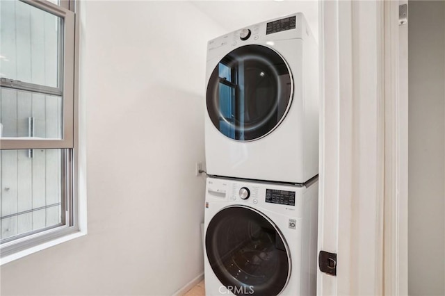 washroom with stacked washer / dryer and laundry area