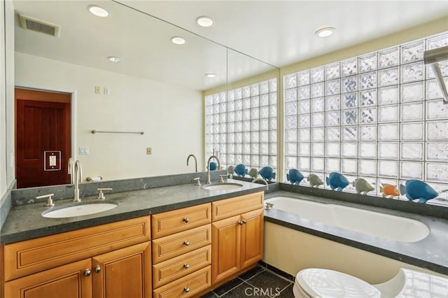full bathroom with a bath, a sink, visible vents, and double vanity