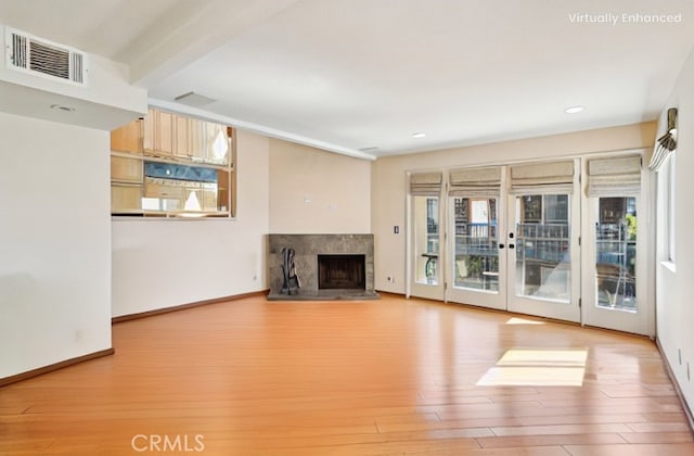 unfurnished living room featuring a fireplace, recessed lighting, visible vents, wood finished floors, and baseboards