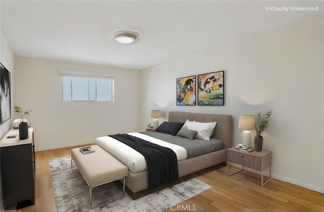 bedroom with baseboards and light wood finished floors