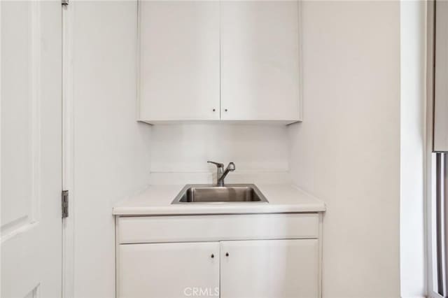 laundry area with a sink