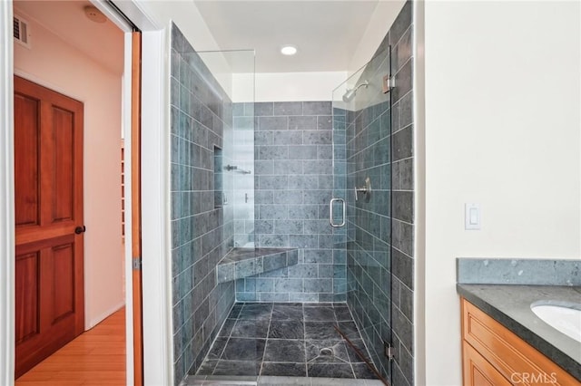 full bath featuring visible vents, a shower stall, and vanity