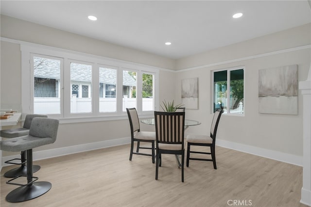 dining area featuring recessed lighting, baseboards, and light wood finished floors