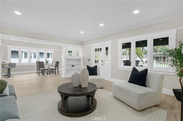 living area with crown molding, baseboards, wood finished floors, and recessed lighting