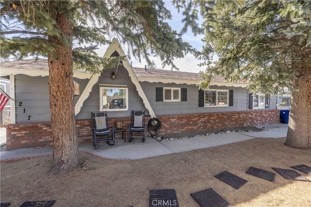 rear view of property featuring brick siding