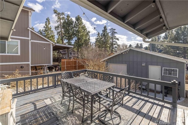 deck with an outdoor structure and outdoor dining space