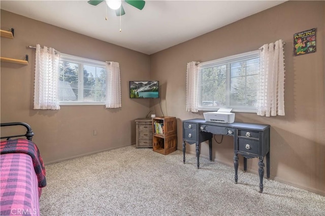 interior space with carpet floors, ceiling fan, and baseboards