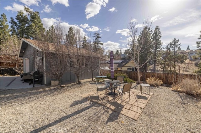 exterior space featuring outdoor dining space, a patio area, and fence