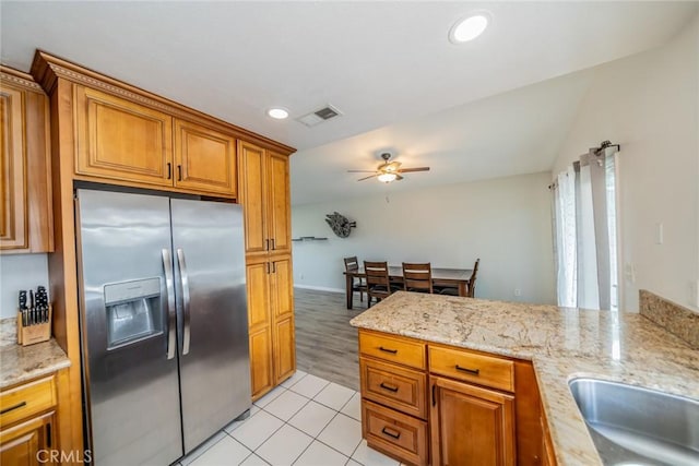 kitchen featuring brown cabinetry, a ceiling fan, visible vents, recessed lighting, and stainless steel refrigerator with ice dispenser