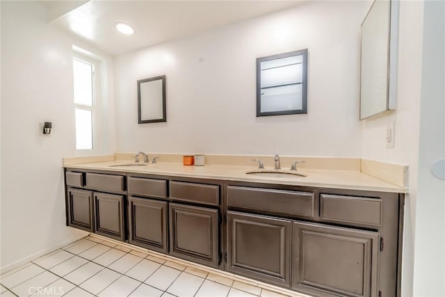 bathroom with double vanity, tile patterned flooring, a sink, and recessed lighting