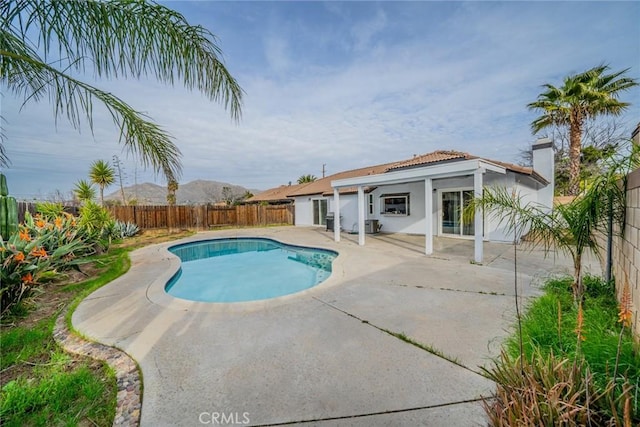 view of swimming pool with a fenced backyard, a fenced in pool, and a patio area