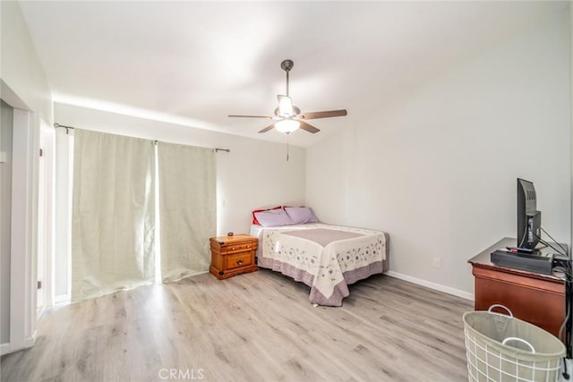 bedroom featuring baseboards, ceiling fan, and wood finished floors