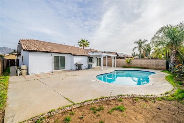 view of pool featuring a patio area, grilling area, a fenced backyard, and a fenced in pool