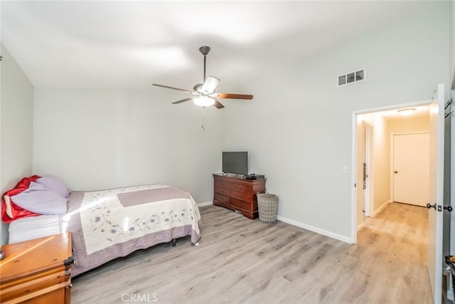 bedroom with baseboards, vaulted ceiling, a ceiling fan, light wood-style floors, and visible vents