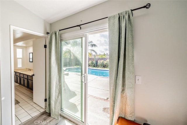 doorway to outside featuring a sink