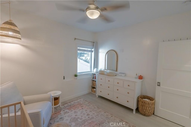 sitting room featuring ceiling fan and baseboards