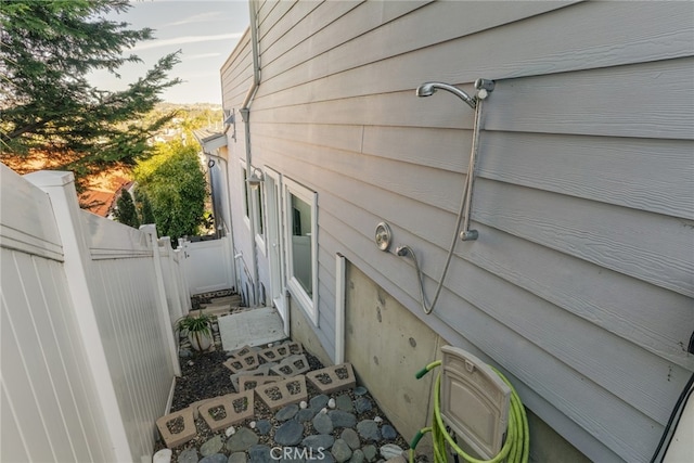 view of home's exterior featuring fence